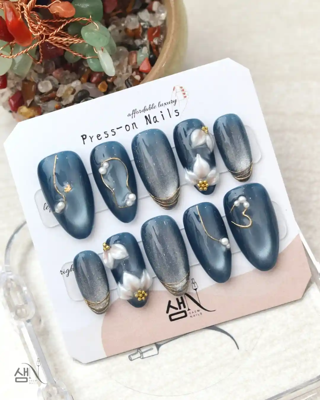 Dark blue-gray set with pearls, gold lines, and white floral accents