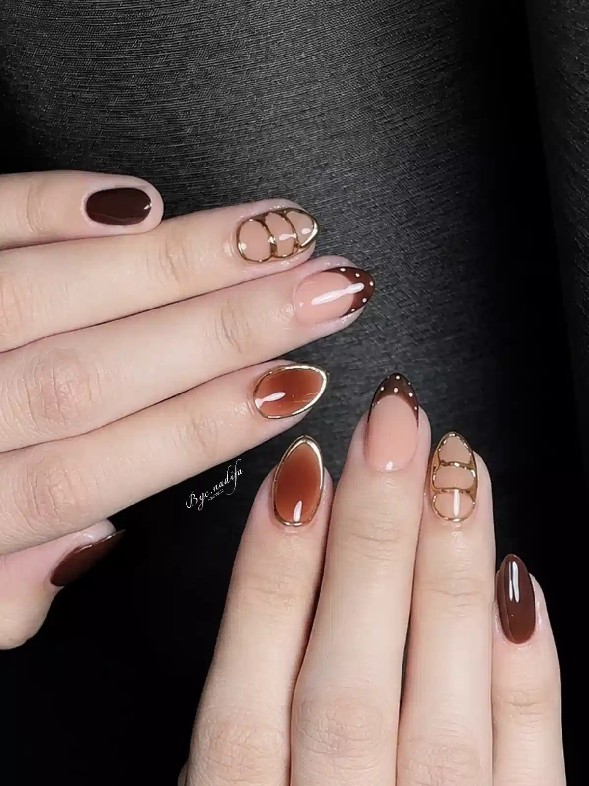 Brown French tips with gold outlines and dotted accents
