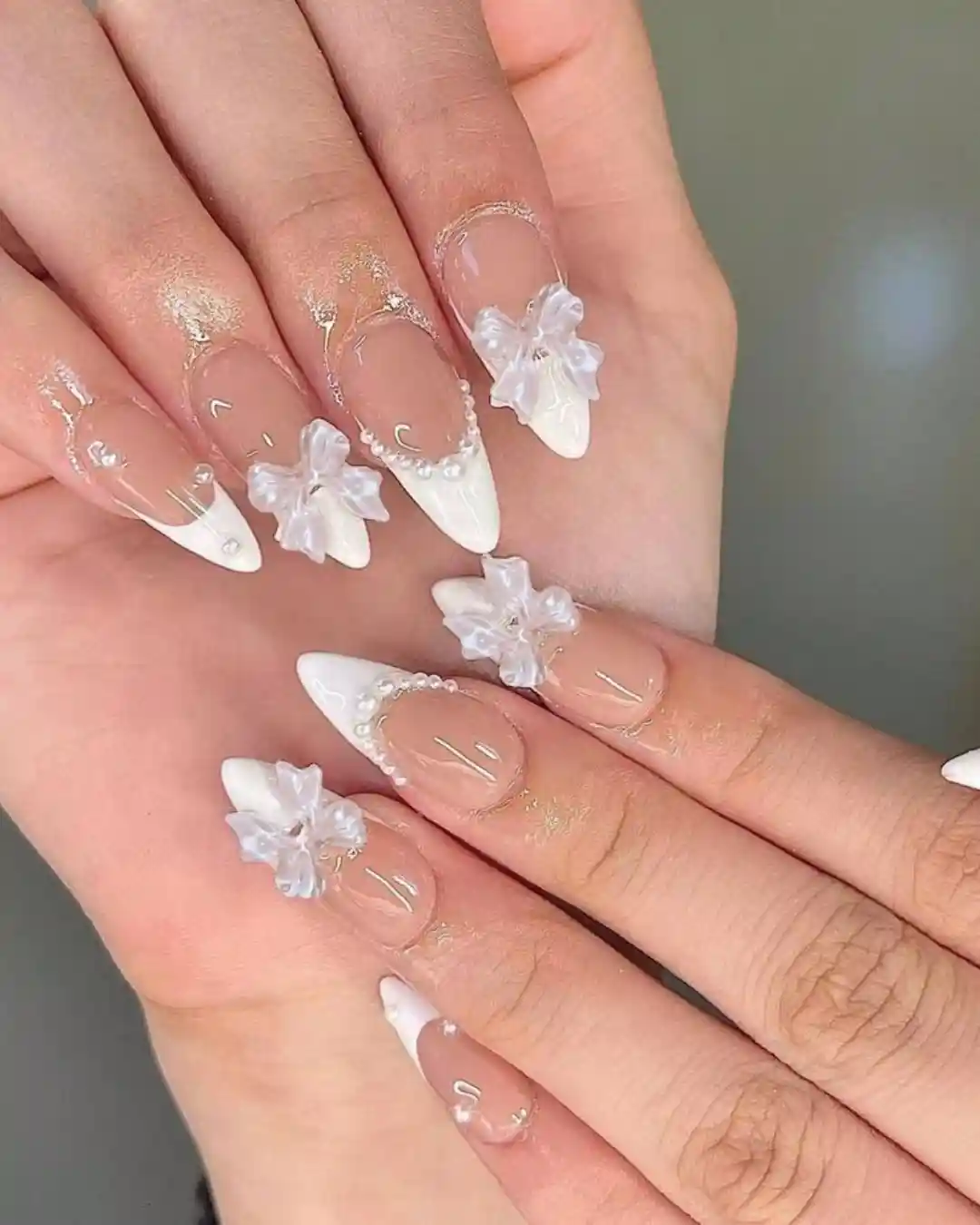 White French tips with translucent 3D flowers and pearls