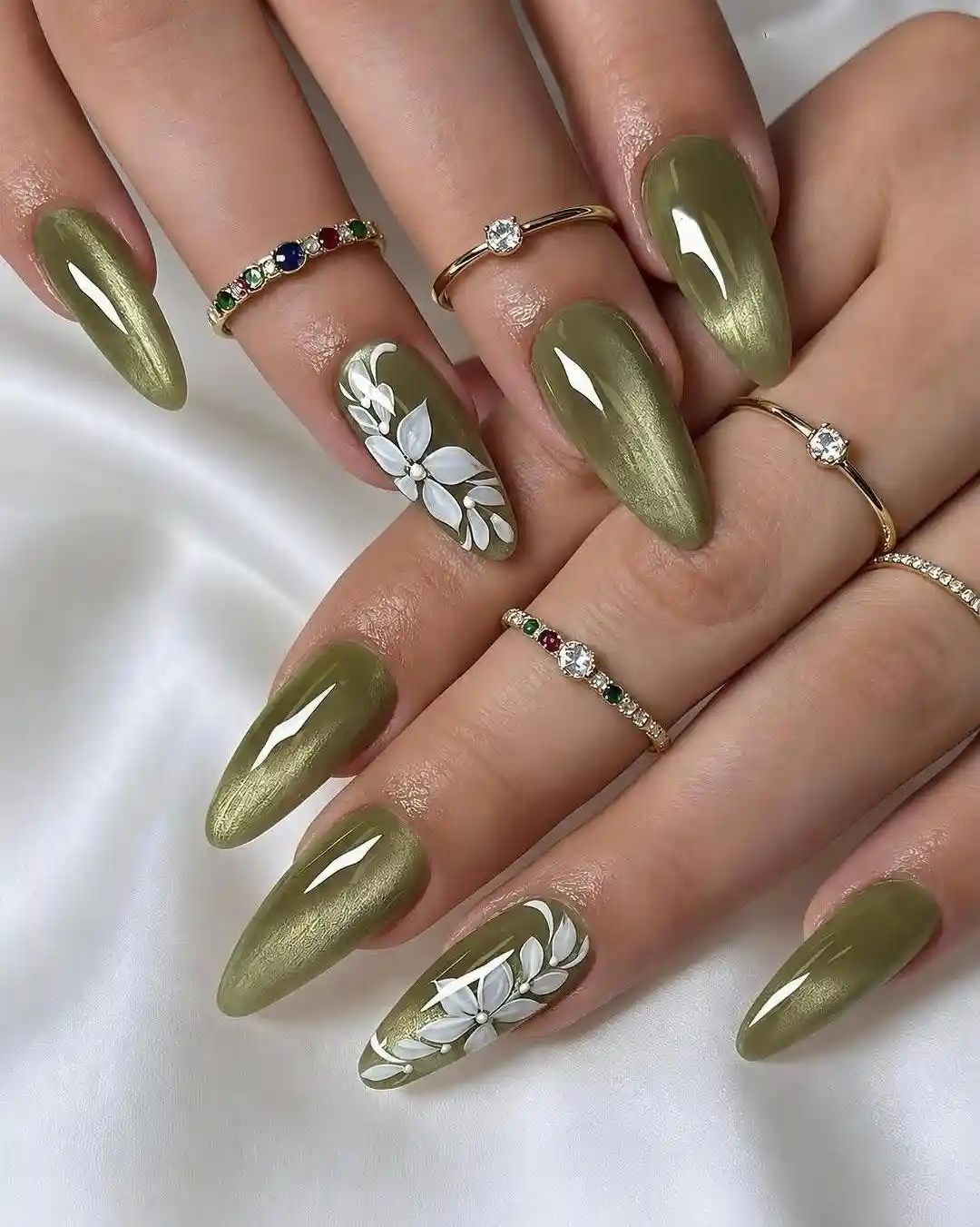 Olive metallic nails with white floral accents