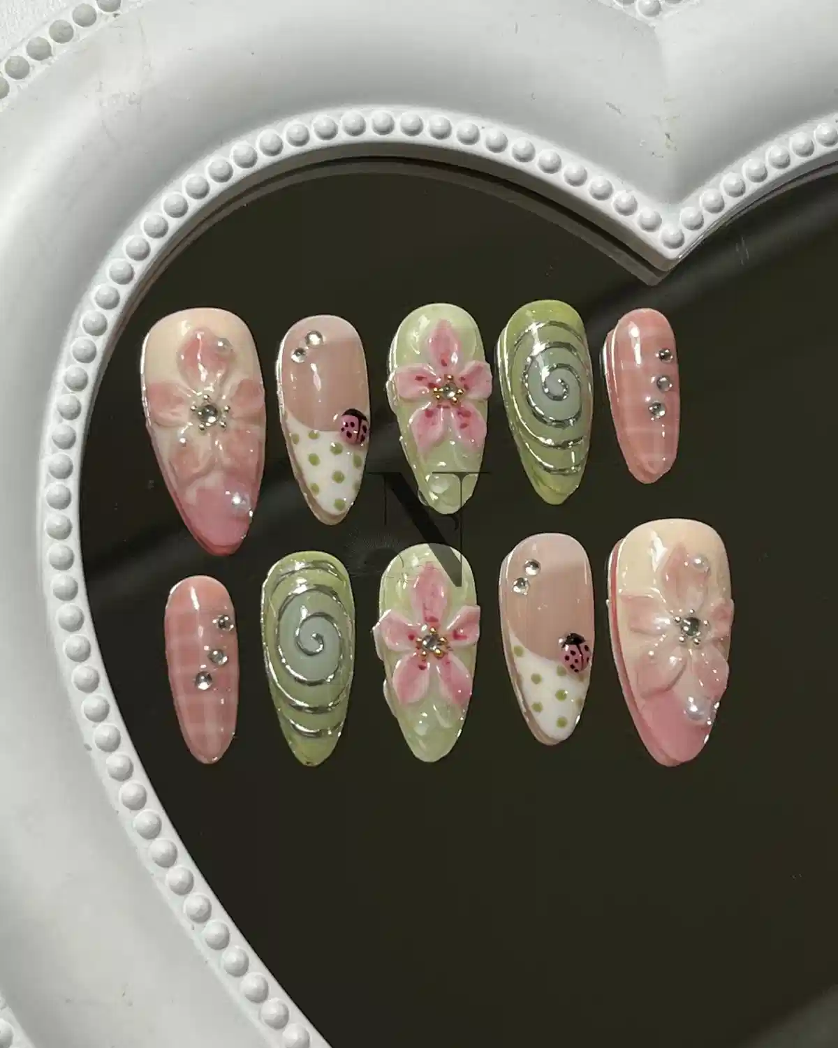 Pink and green floral set with swirls, polka dots, and ladybug detail
