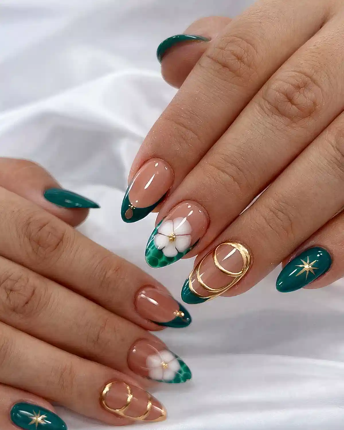 Green French tips with white flowers and gold accents