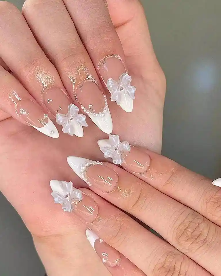 Pointed white French tips with 3D flowers
