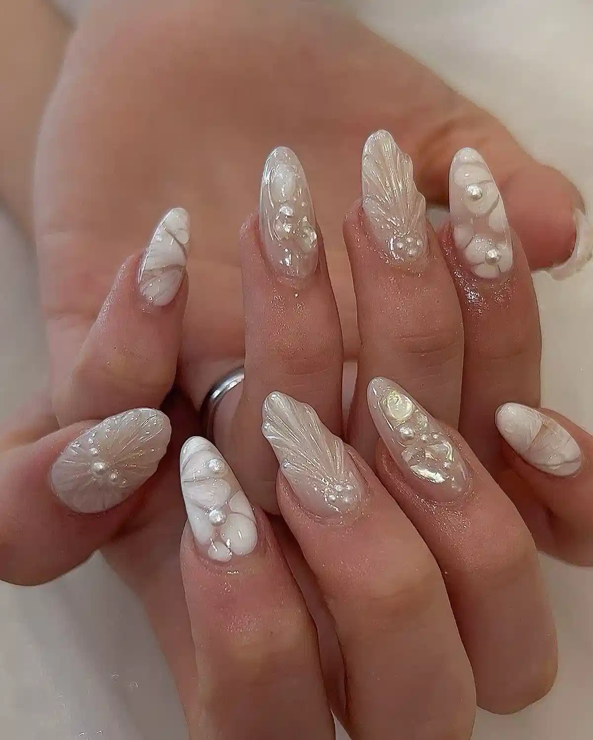Long almond set with white swirls, pearls, and raised textures