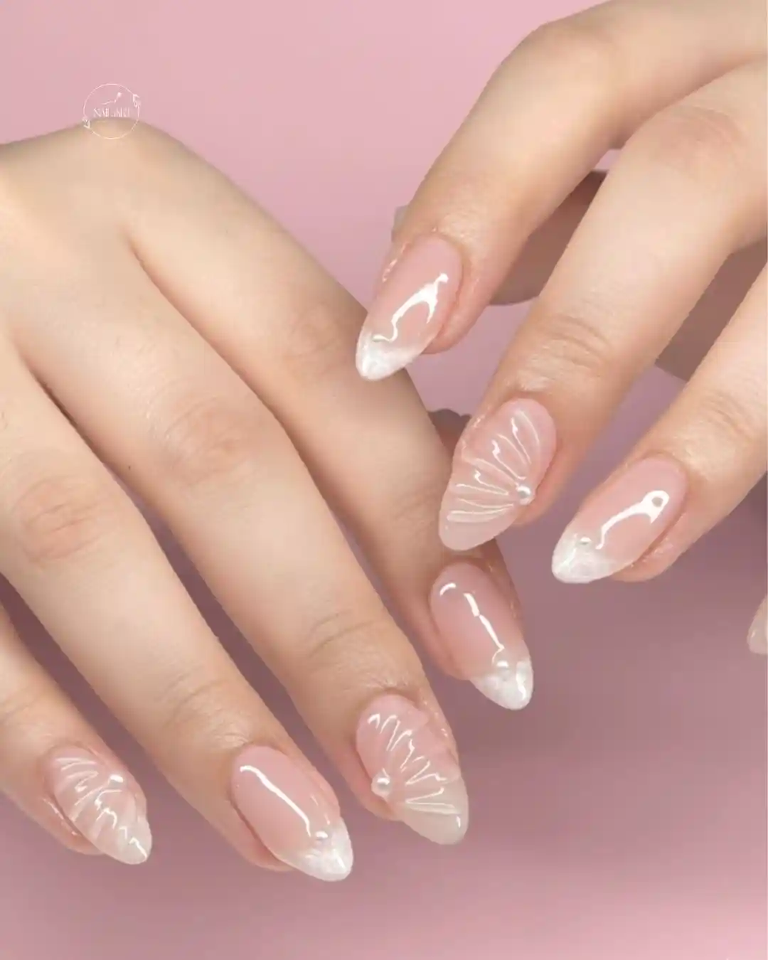 Sheer nude nails with white marbled tips and raised fan linework