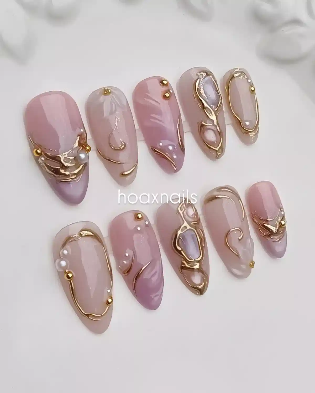 Nude and lavender set with raised gold-toned framing and stud accents