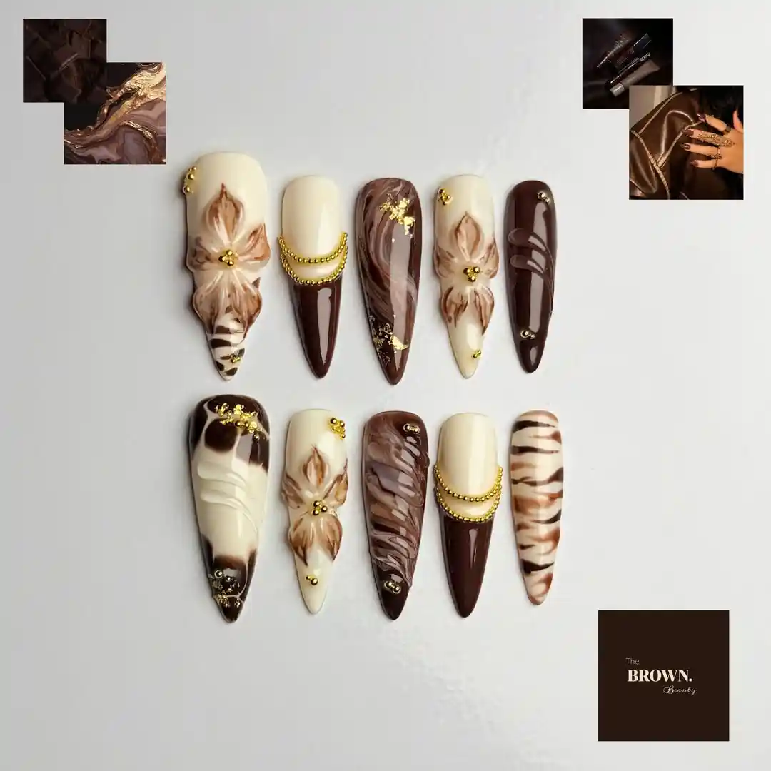 Brown and cream stiletto set with marbling, striping, and gold accents