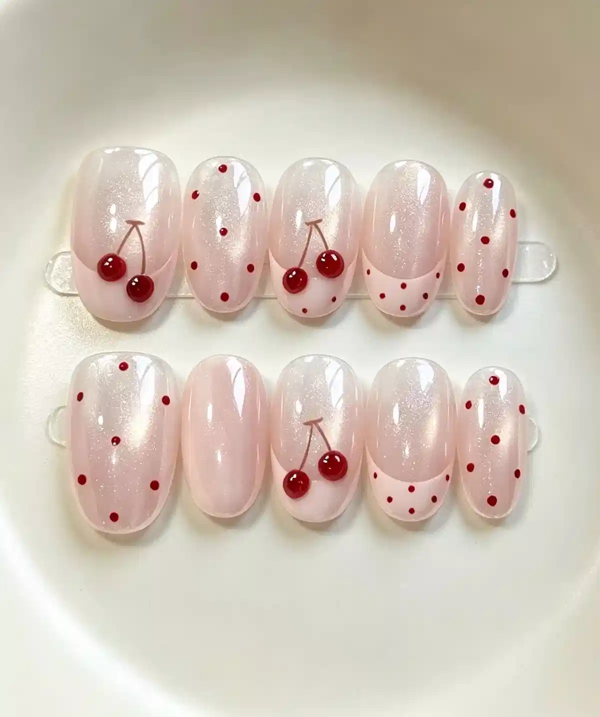 Pale pink shimmer set with red polka dots and cherry motifs