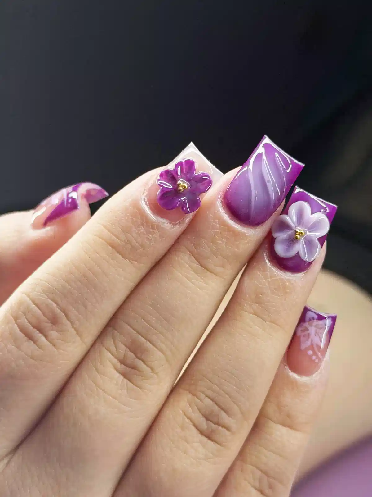 Short square purple nails with 3D flowers and fine white linework