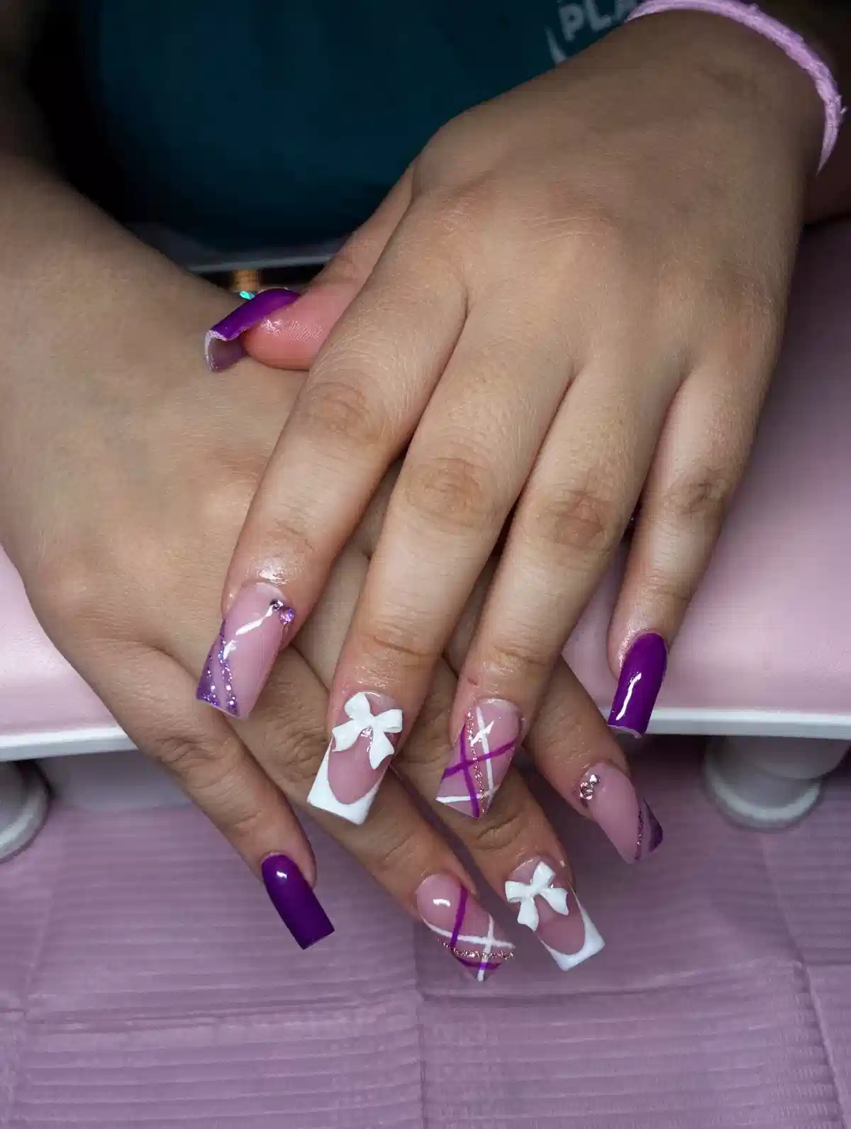 Purple and nude coffin nails with bows and diagonal striping