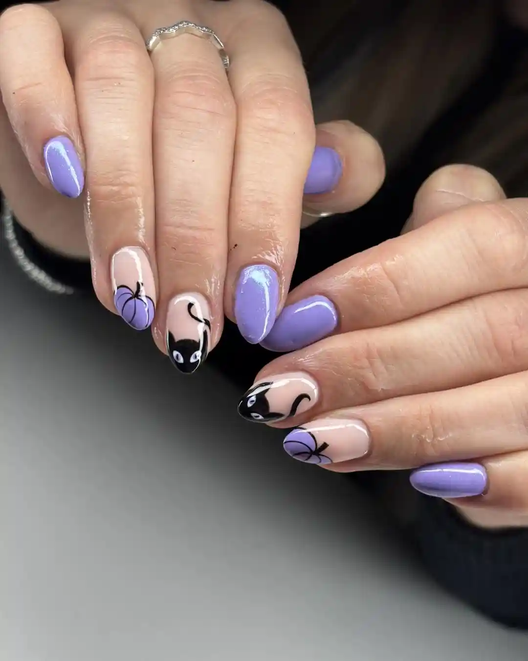 Lavender solids with black cat-face nail art