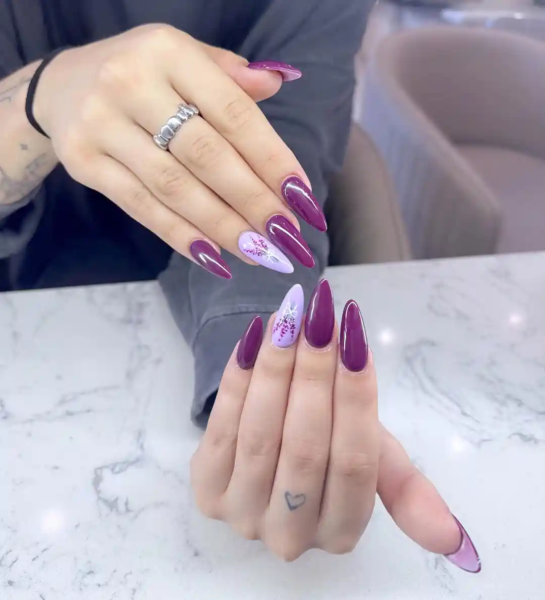 Deep purple solids with lavender floral accent nails