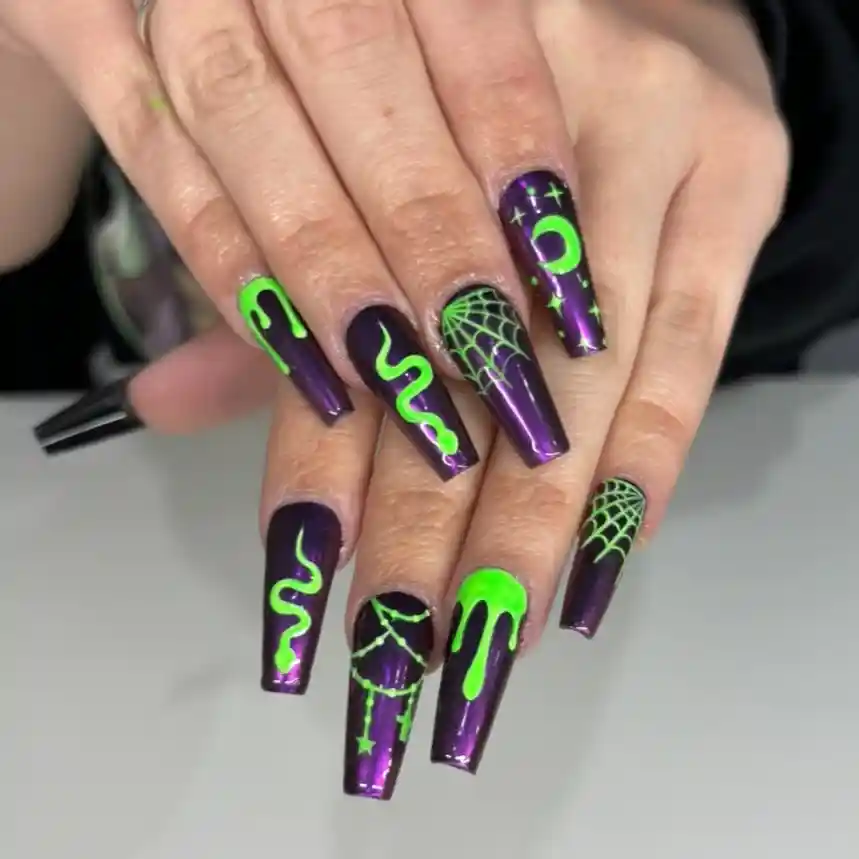 Dark purple coffin nails with neon green drips, snake line, web, and moon motifs
