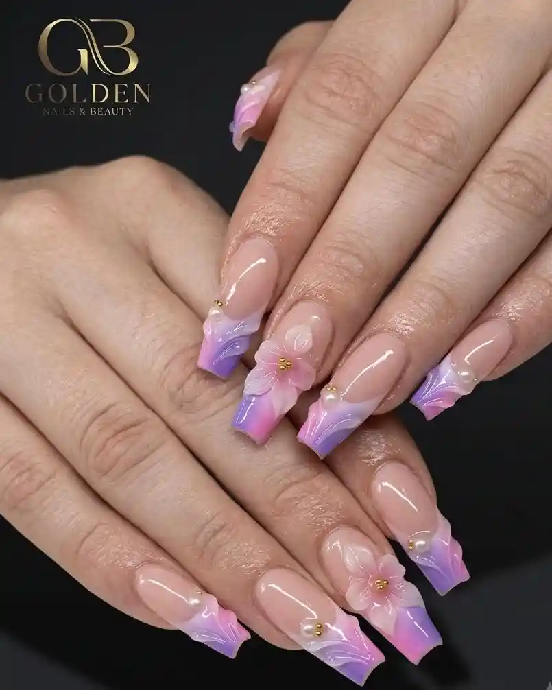 Nude base with purple-pink gradient French tips and floral details