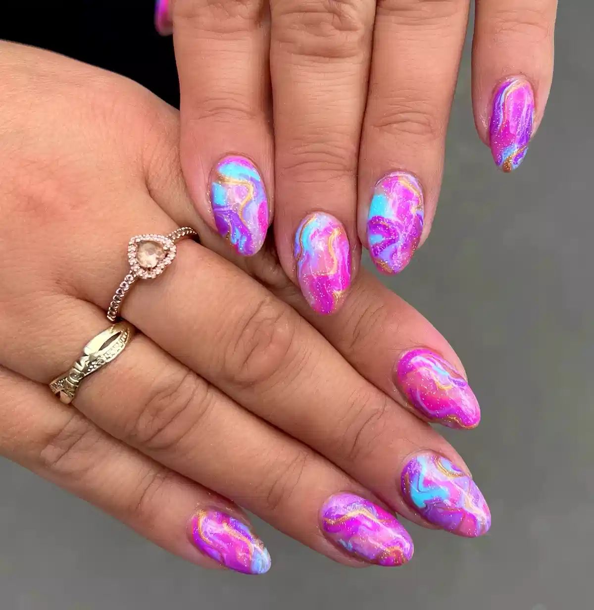Pink–purple–blue marbled swirls with gold-toned lines