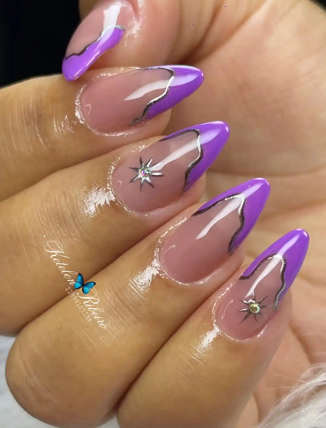 Purple French tips with silver outline and starburst gems