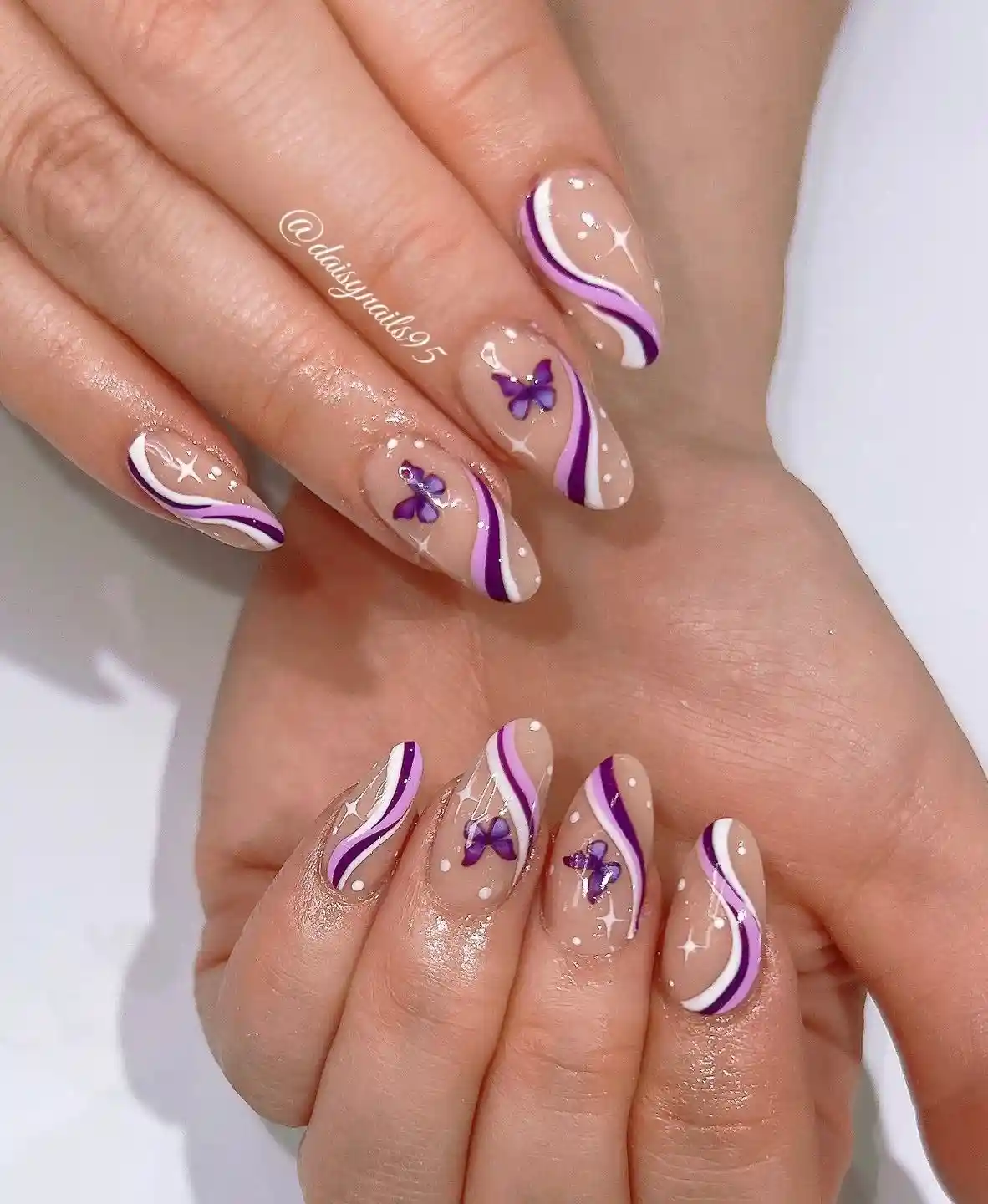 Nude base with purple-and-white waves and butterfly accents