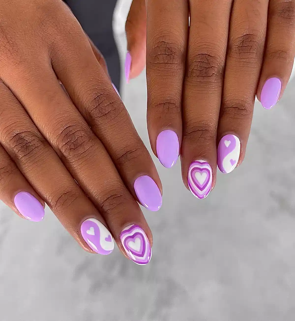 Lavender nails with heart-pattern accents
