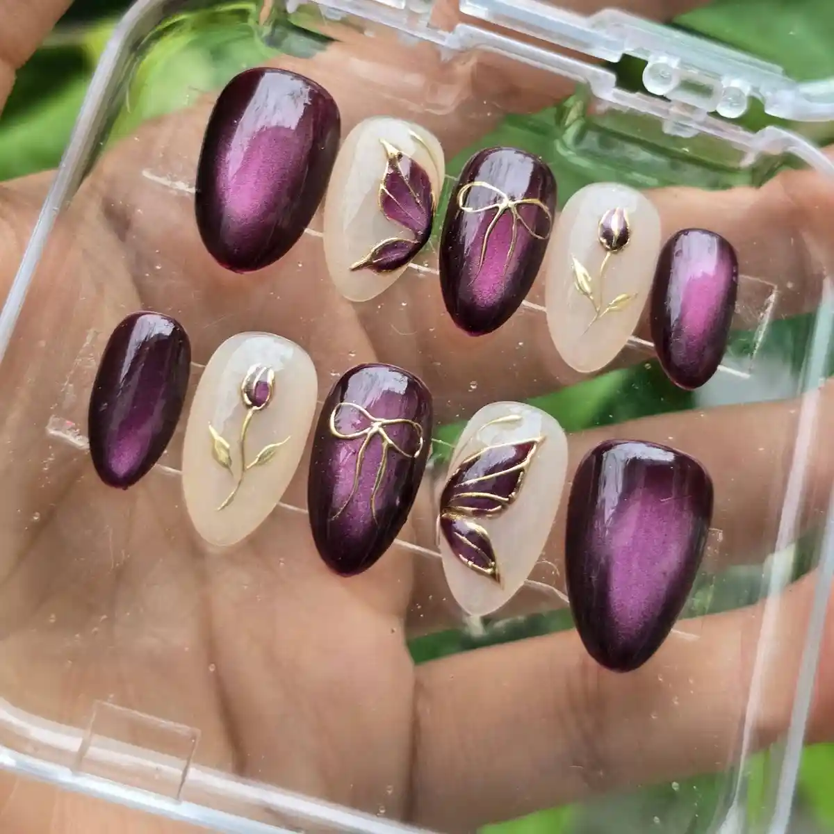 Deep plum cat-eye set with cream-and-gold botanical accents