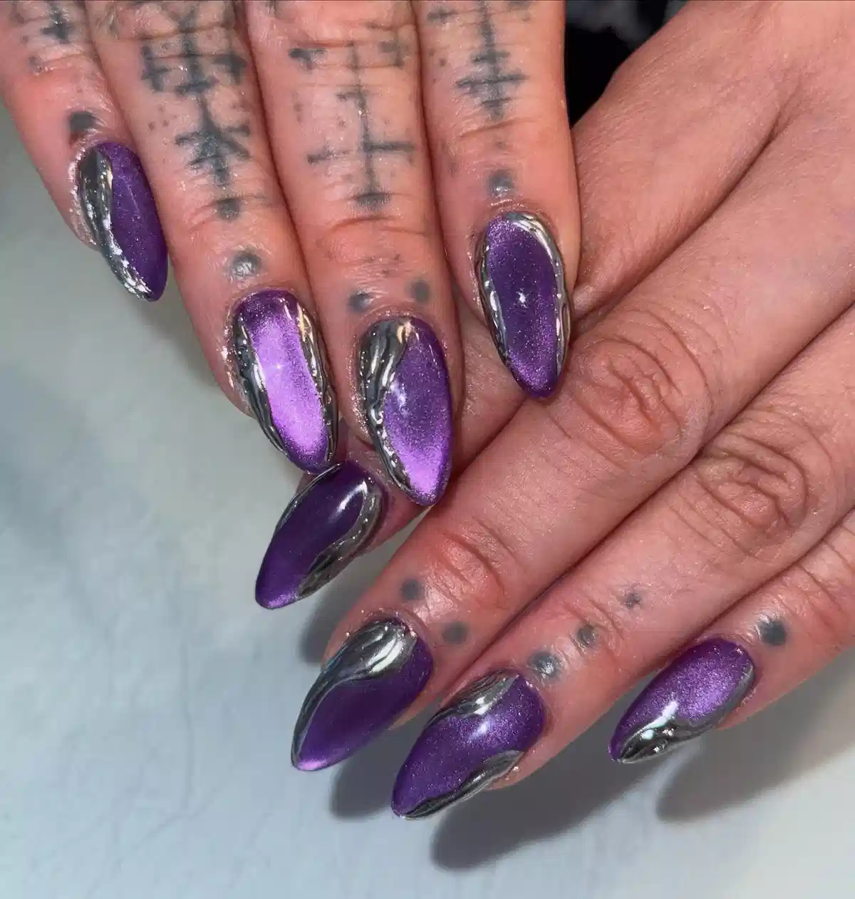 Purple metallic nails with silver chrome side borders