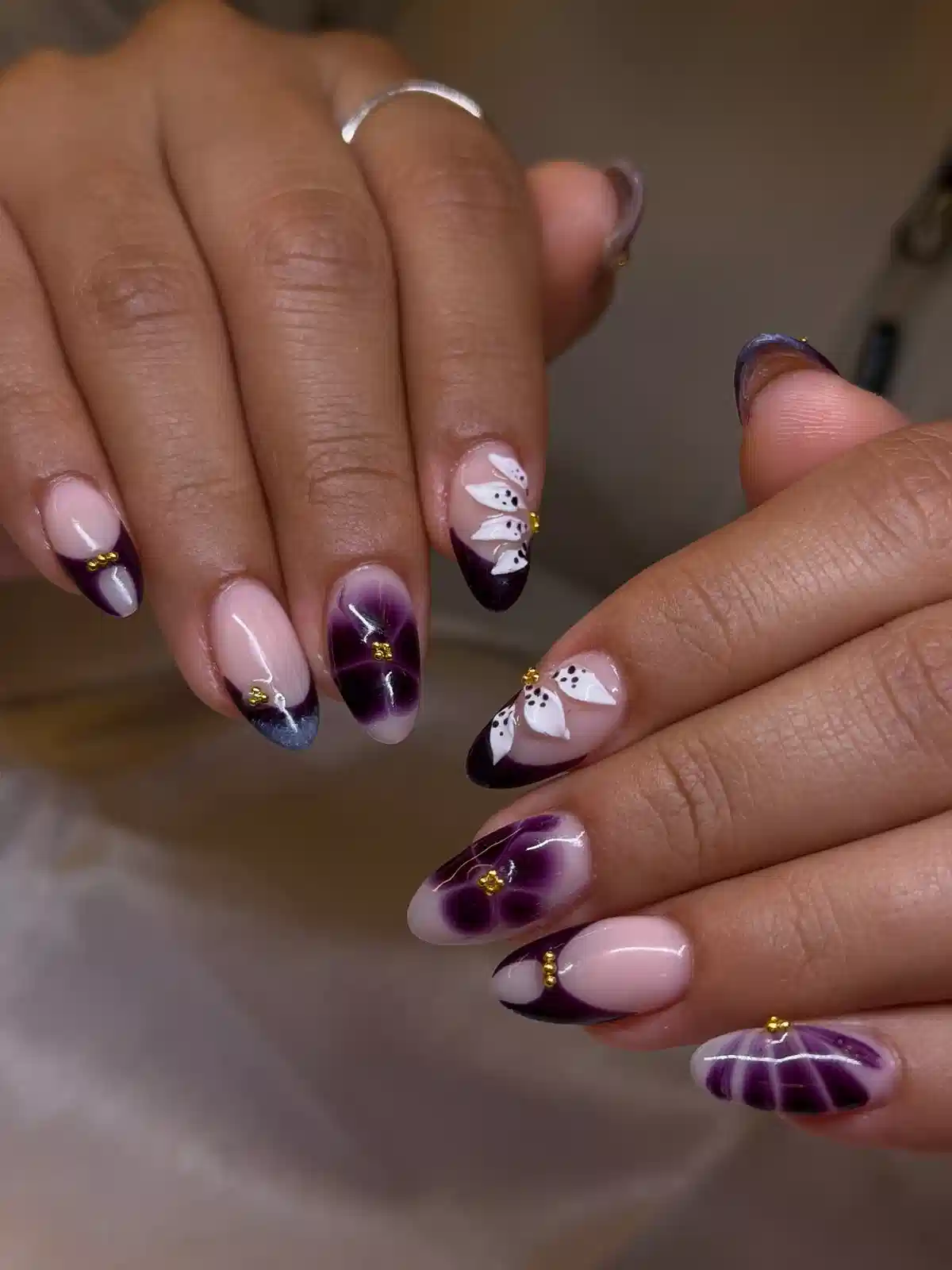 Nude base with deep-purple tips and floral centers