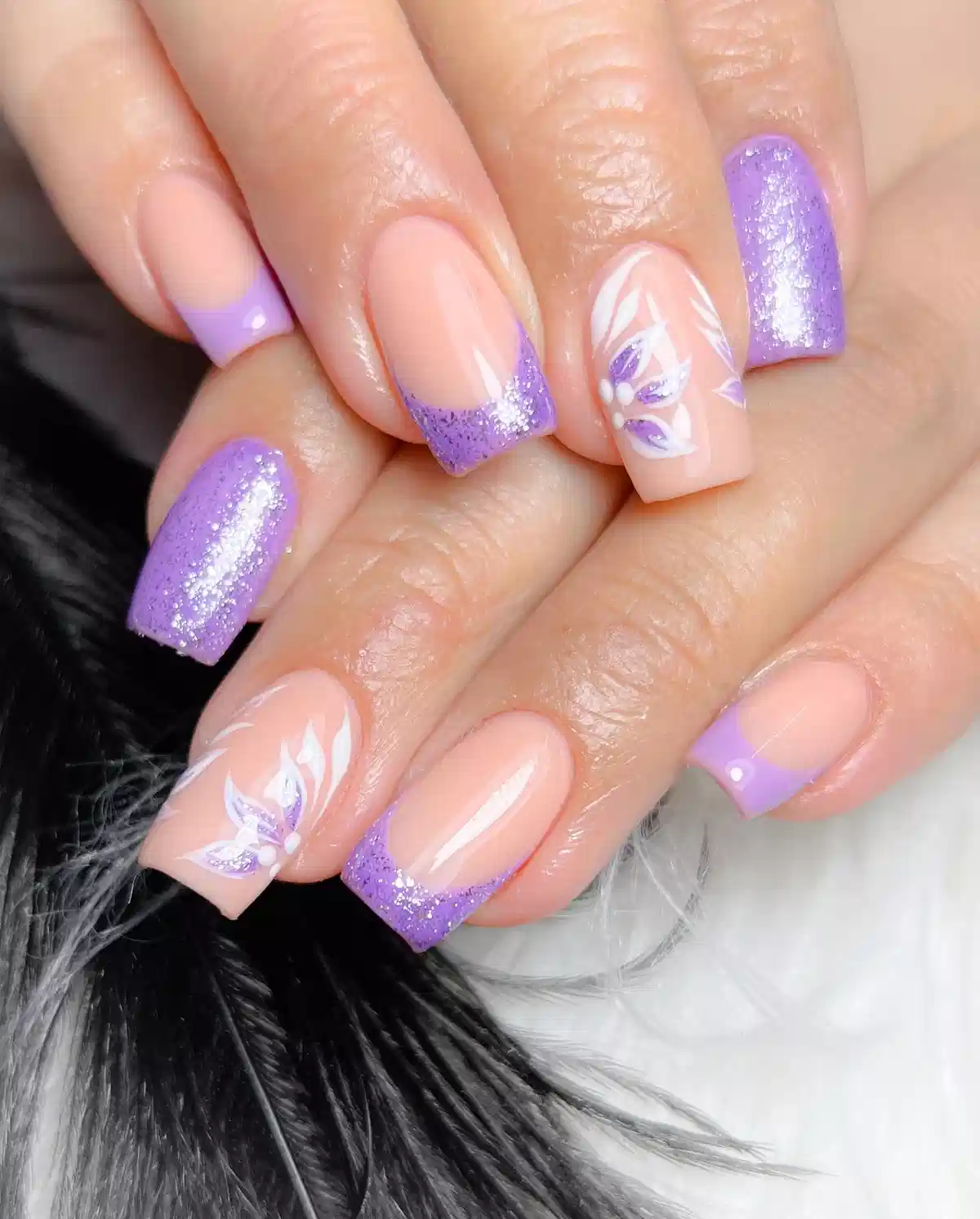 Glitter lavender French tips with white floral accents