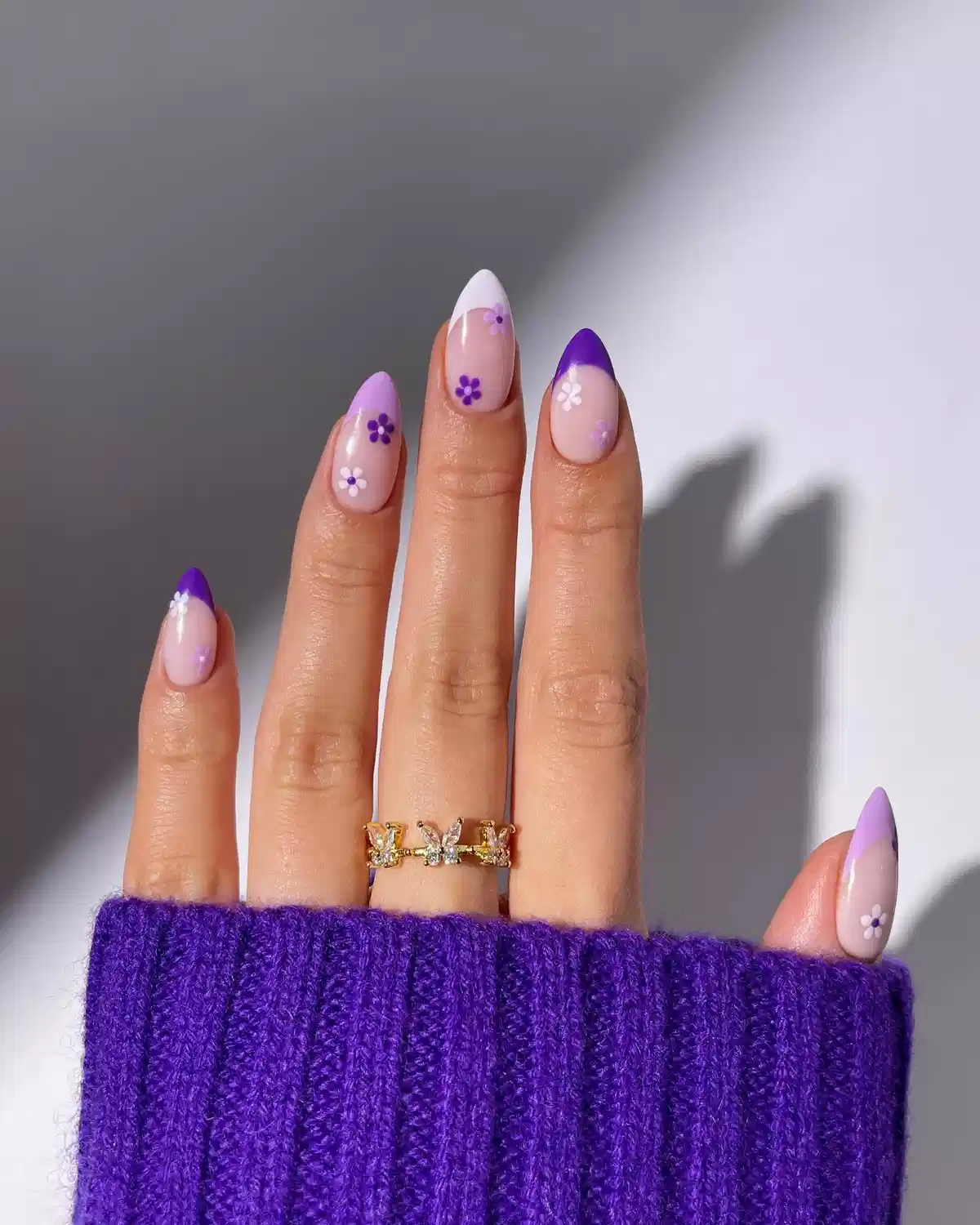 Purple-and-white French tips with small flower motifs