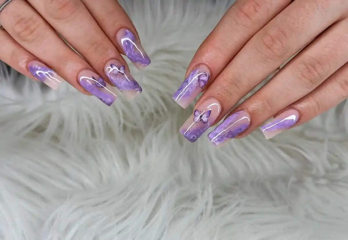 Translucent square nails with purple marbling and fine line details