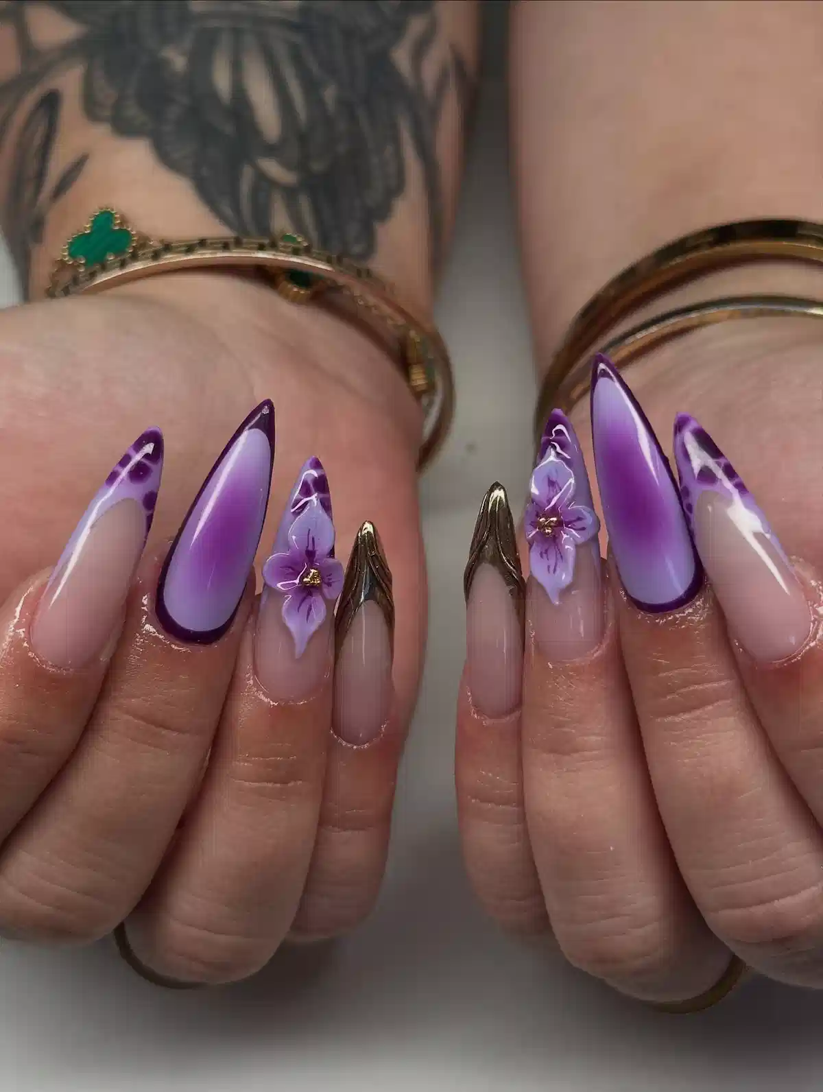 Stiletto purple gradients with outlined edges and floral accents