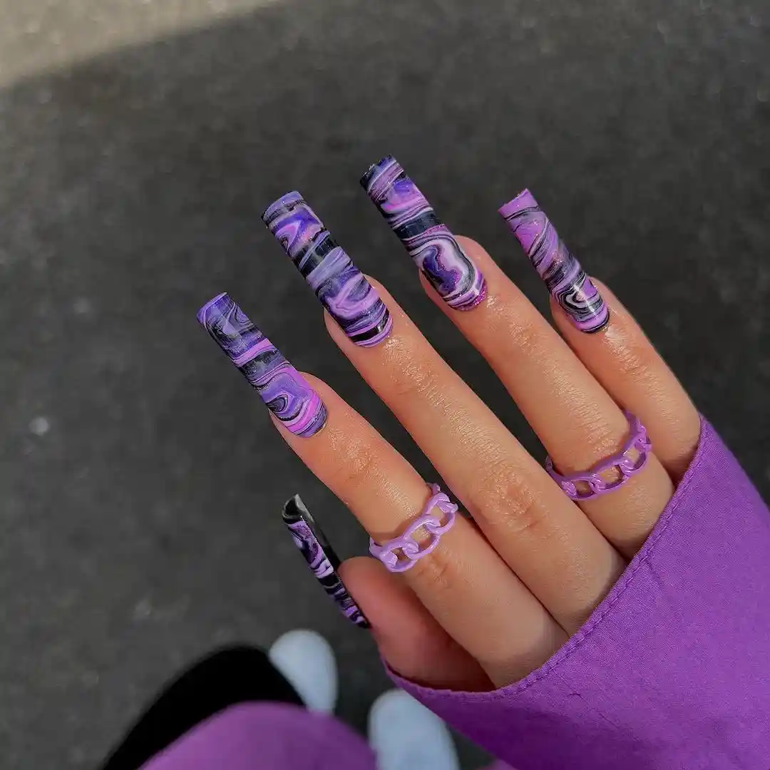 Purple-and-black marbled square nails with matching purple accessories