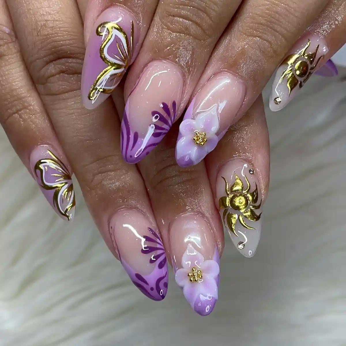 Almond nude base with purple botanical motifs and gold accents