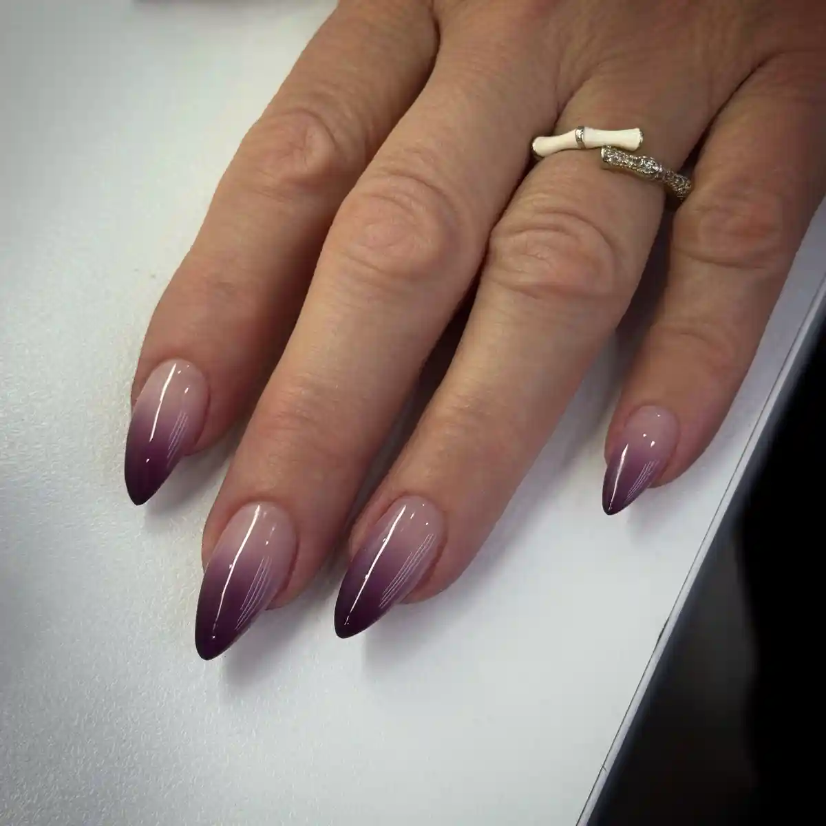 Subtle Nude-to-Deep Purple Ombre Almond Nails