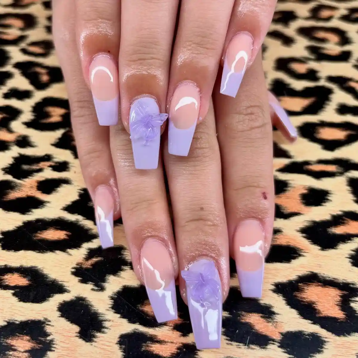 Pale lavender French tips with large 3D floral accents