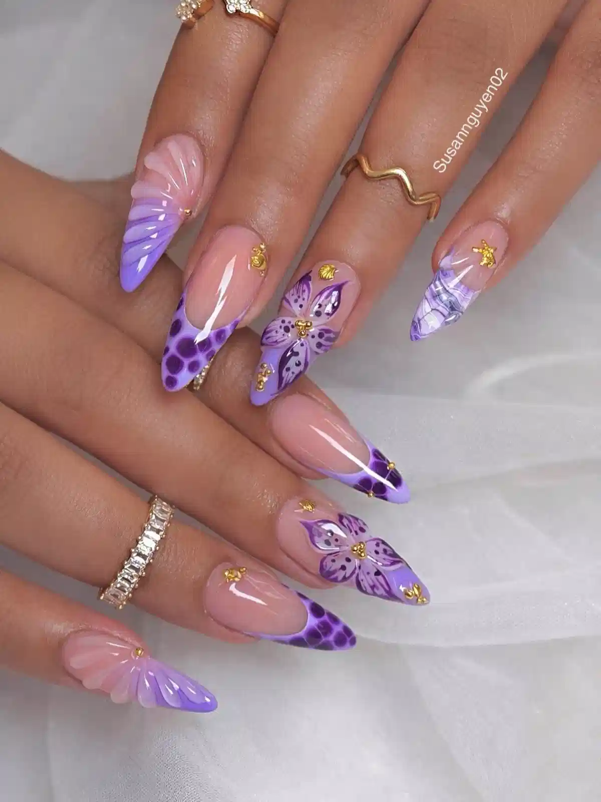 Purple ombré almond nails with butterfly art and gold accents