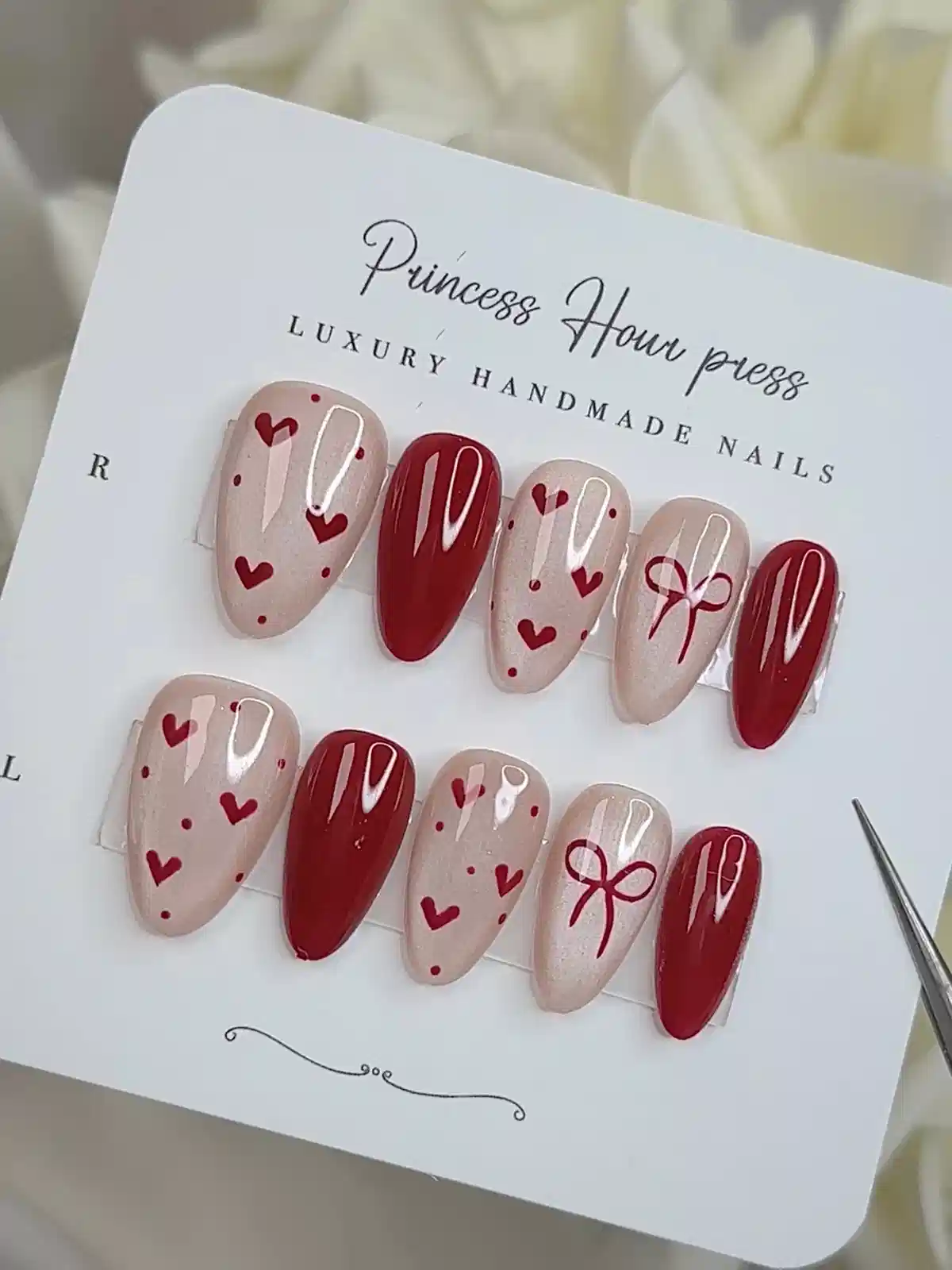 Red and nude heart-pattern press-ons with bow detail