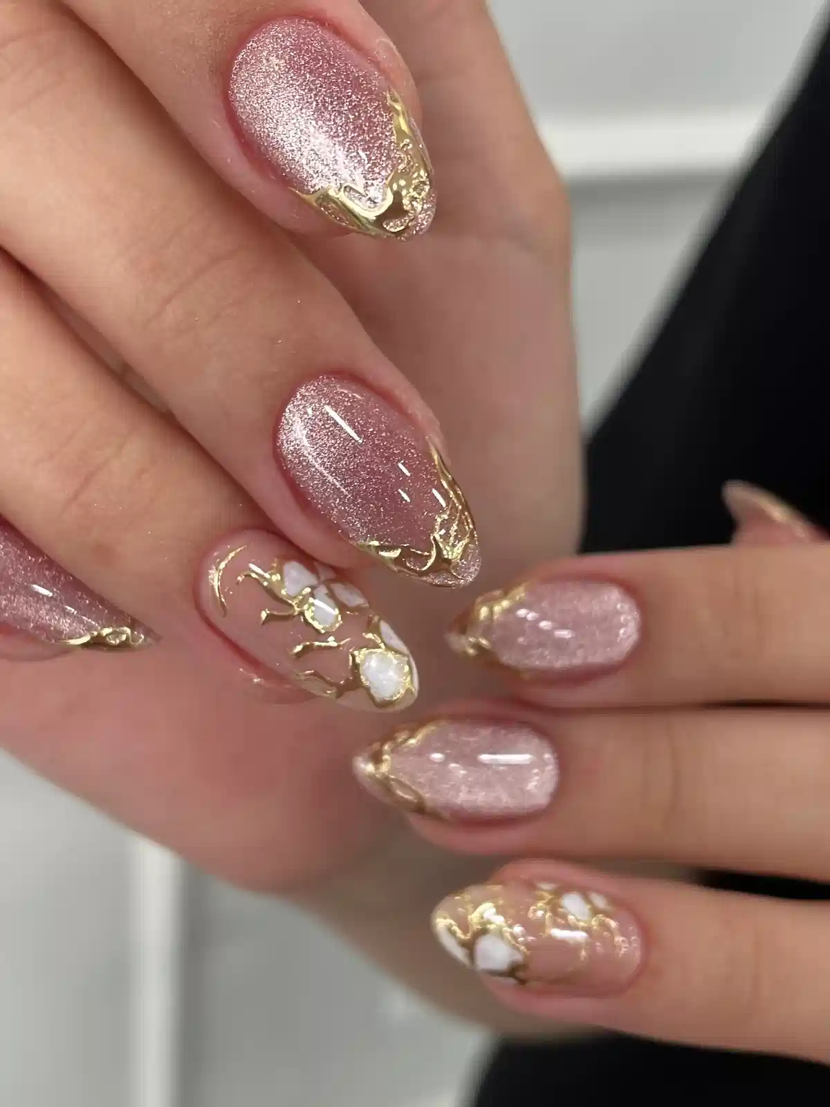 Rose glitter nails with gold-edged tips and white-gold accent detail
