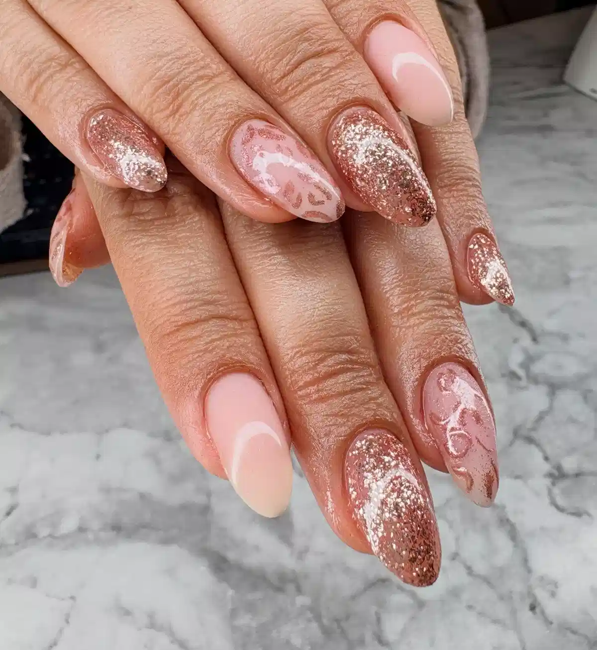 Rose-gold glitter accents with pale pink abstract swirls