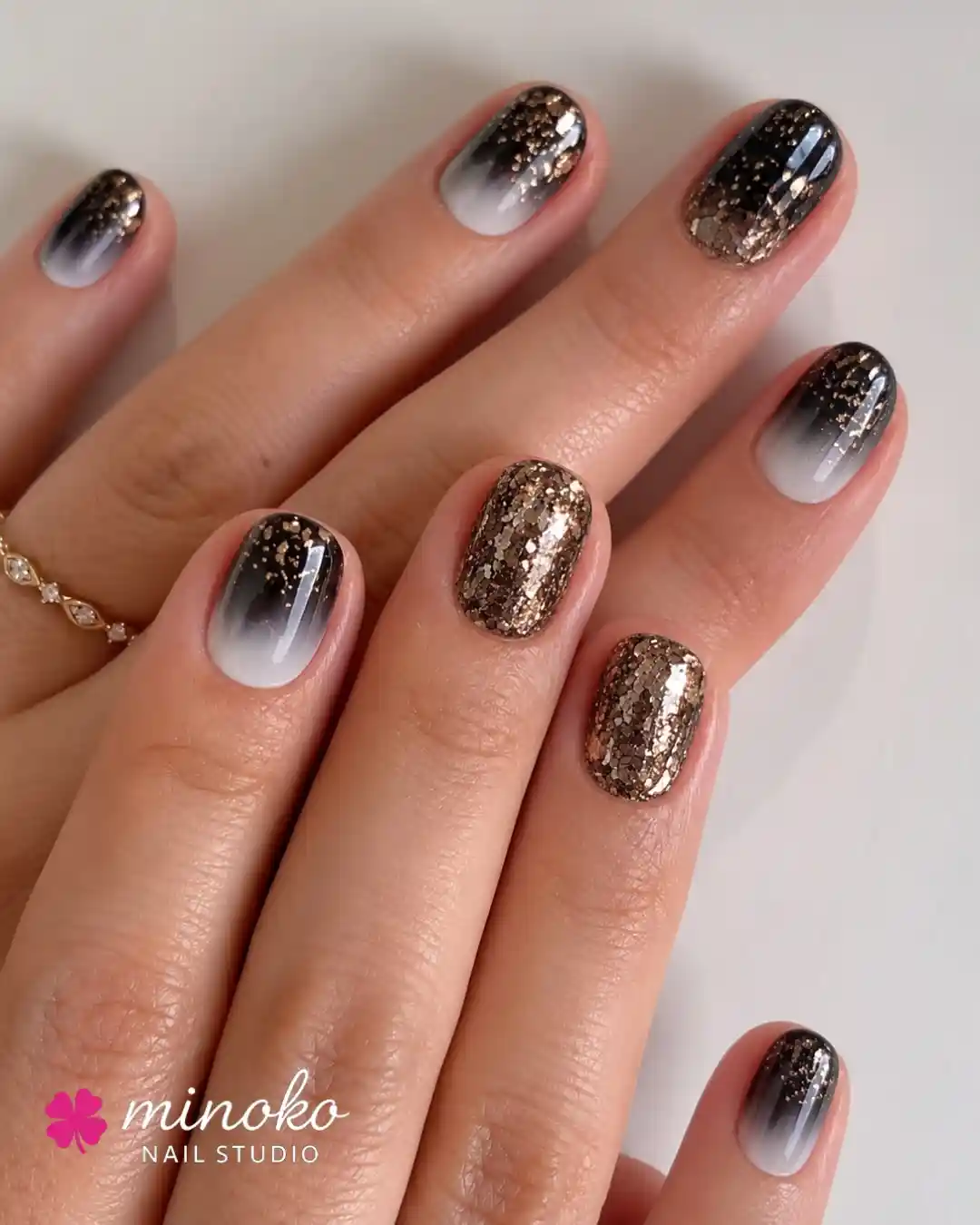 Black-to-White Gradient with Gold Glitter Accent Nails