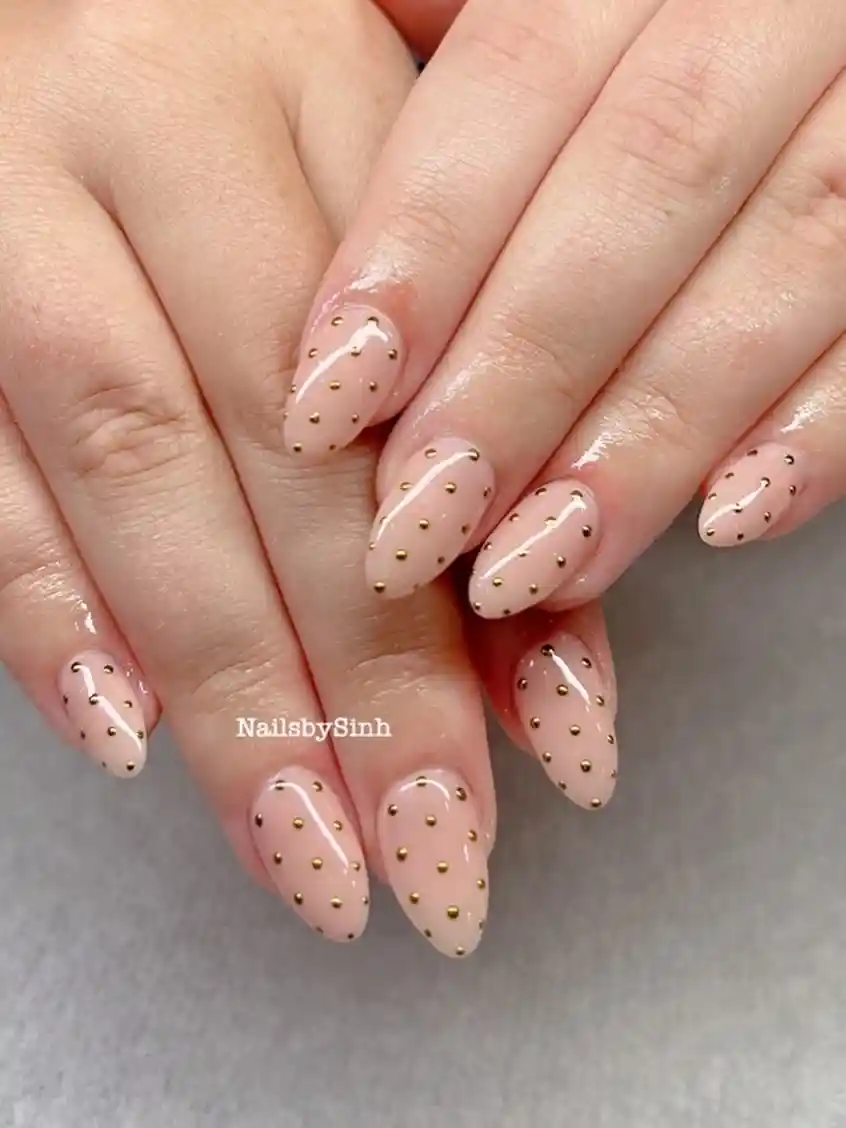 Glossy Nude Almond Nails with Gold Dots