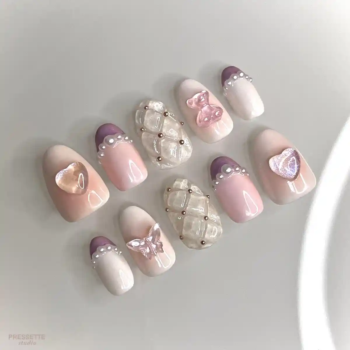 Pink and purple French tips with 3D butterfly and bow