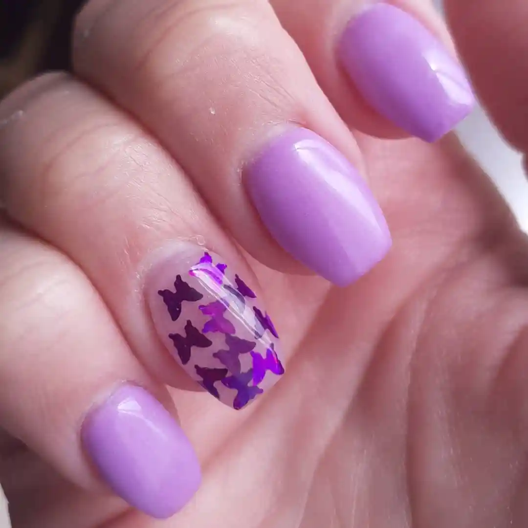 Lavender nails with purple butterfly accent