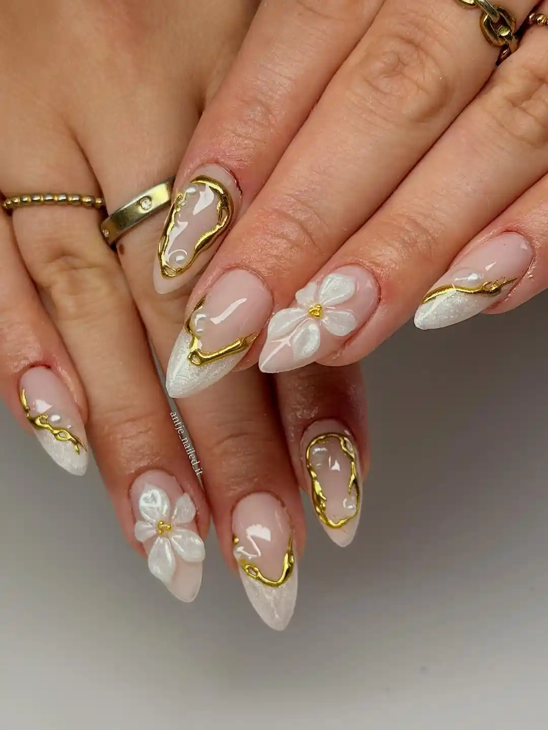 Gold-outlined frames with white 3D flowers