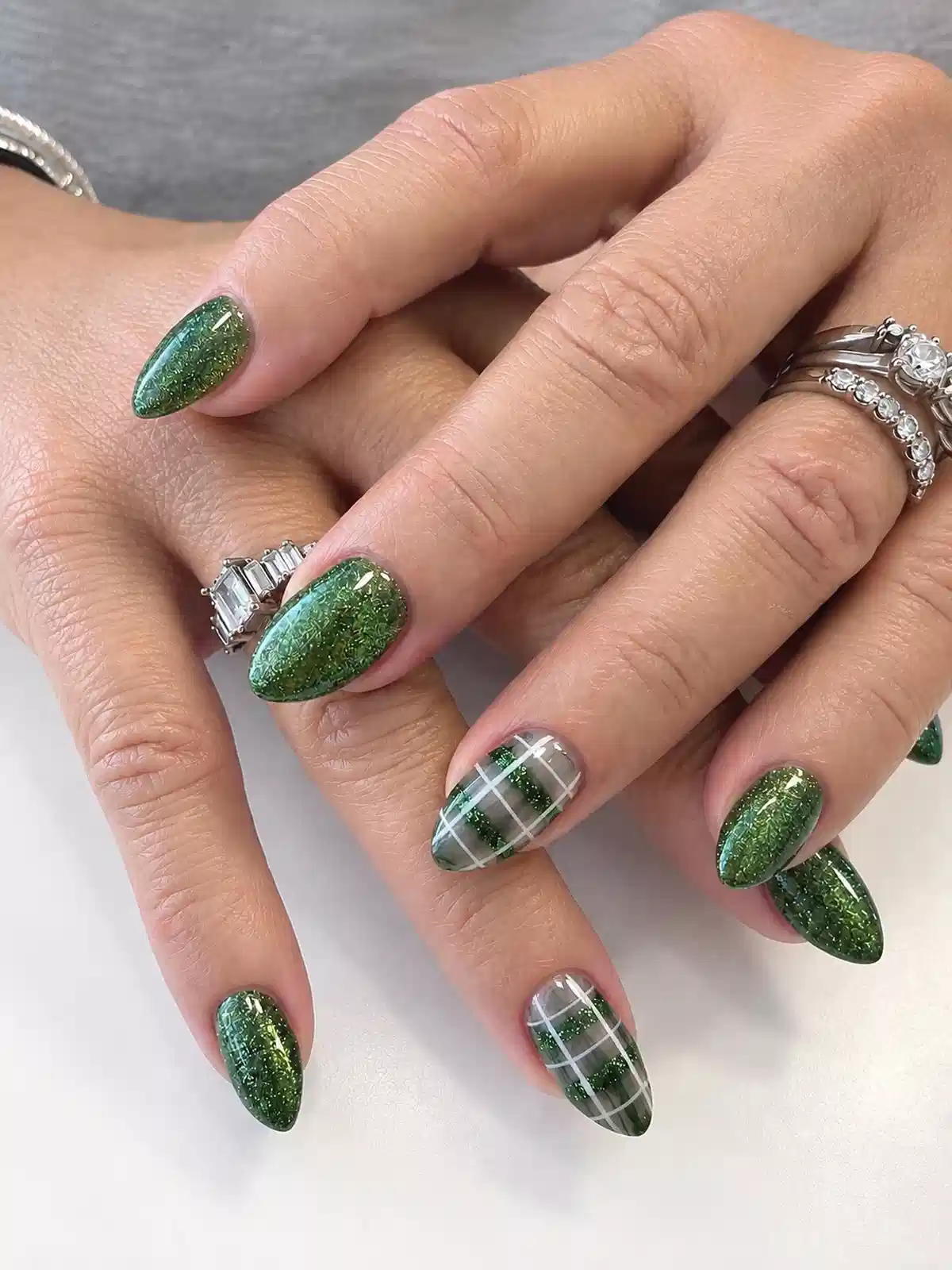 Green Glitter Almond Nails with Gray-and-White Plaid Accents